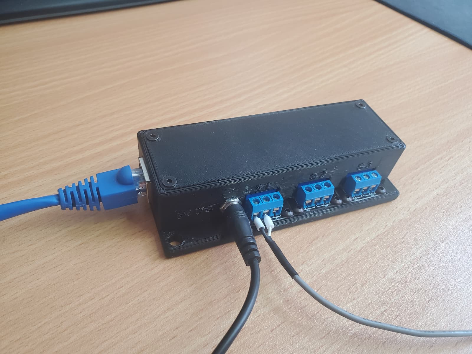ArtSwitch in its black enclosure with Ethernet, power and three relay terminals